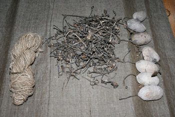 Tropical tasar cocoons (right), removed peduncles (centre) and yarn spun with peduncles